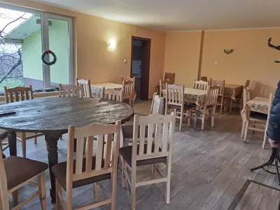 a dining room with a table and chairs at Винарна-Славовица in Kalugerovo