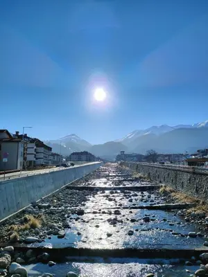a river with rocks and the moon in the sky at Belvedere luxury apartment in Bansko