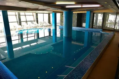 a large swimming pool in a large building at Belvedere luxury apartment in Bansko