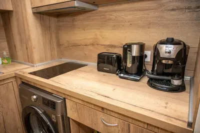 a kitchen counter with a coffeemaker and a coffee maker at All Seasons Apartments Borovets Gardens in Borovets