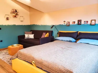 a bedroom with a bed and a couch at Borovets Forest view (A56) in Borovets