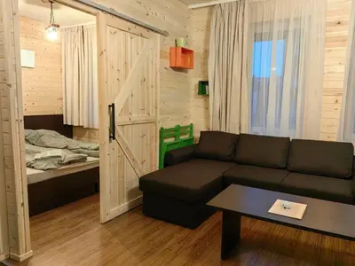 a living room with a couch and a bed at Bansko Royal Towers - Studio 815 in Bansko