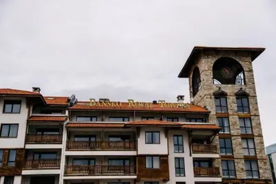 a building with a clock tower on top of it at Bansko Royal Towers - Studio 815 in Bansko