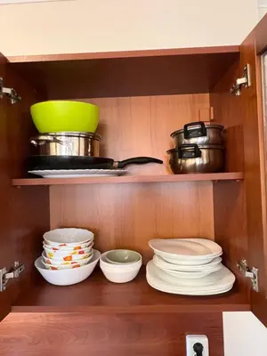 a shelf with plates and bowls in a kitchen at Vesta Boutique Apartment in Bansko