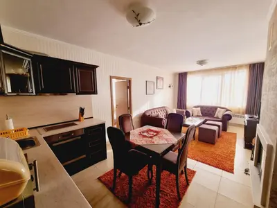 a kitchen and living room with a table and chairs at Гранд Манастира Пампорово, Двустаен апартамент Deluxe in Pamporovo