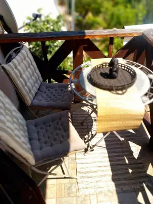 two chairs and a glass table on a patio at vins studio in Bansko