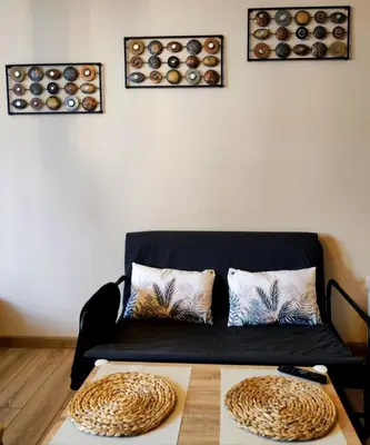 a living room with a black couch and a table at vins studio in Bansko