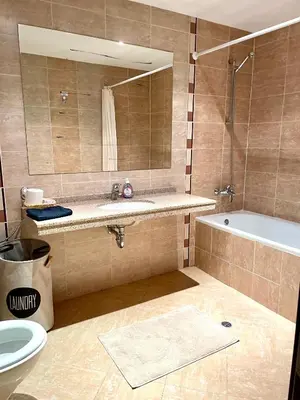a bathroom with a sink and a tub and a mirror at Ground floor 2-bedrooms, 2-bathrooms apartment near Bansko in a complex with pools and SPA included in Razlog