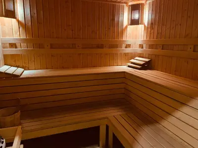 a sauna with a bench in a wooden room at Ground floor 2-bedrooms, 2-bathrooms apartment near Bansko in a complex with pools and SPA included in Razlog