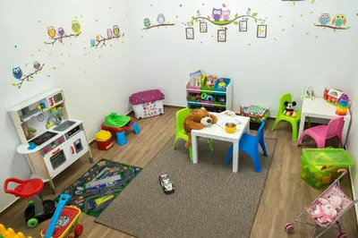 a toy room with a table and chairs and toys at Hotel Niken in Pamporovo