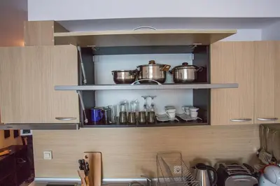 two pots and pans on a shelf in a kitchen at Bright Studio in a Spacious Complex in the Valley by Flat Mаnager in Bansko