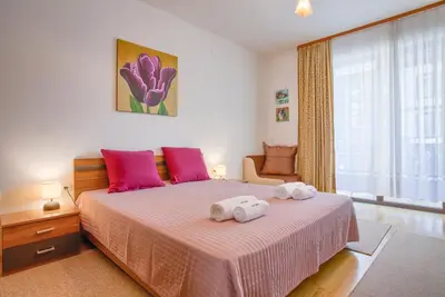 a bedroom with a large bed with two towels on it at Cozy One-Bedroom apartment with Nature View by Flat Mаnager in Razlog
