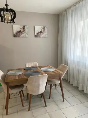a dining room with a wooden table and chairs at Spacious Apartment next to South Park Просторен Апартамент до Южен Парк Top Location in Sofia