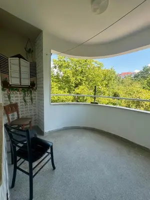 a empty room with a chair and a window at Spacious Apartment next to South Park Просторен Апартамент до Южен Парк Top Location in Sofia