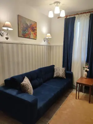 a blue couch sitting in a living room at Bansko Dream Apartment City Center in Bansko