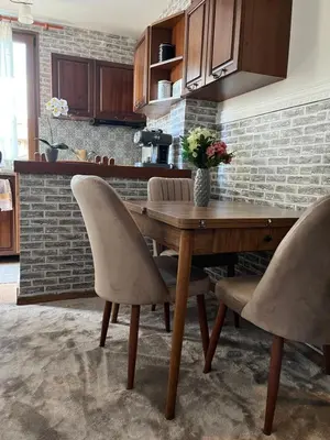 a dining room with a wooden table and chairs at Bansko Dream Apartment City Center in Bansko
