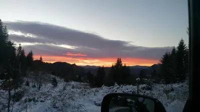 a view of a snow covered mountain with a sunset at Forest Home 524 in Smolyan