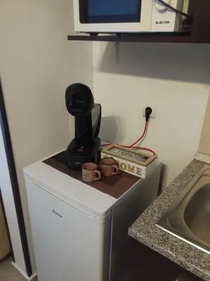 a coffee maker sitting on top of a refrigerator at Студио Snow day в Green life в Банско in Bansko