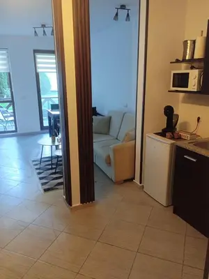 a living room with a couch and a table at Студио Snow day в Green life в Банско in Bansko
