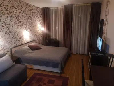 a hotel room with a bed and a television at Snowflake Studio in Borovets