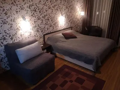 a small bedroom with a bed and a chair at Snowflake Studio in Borovets