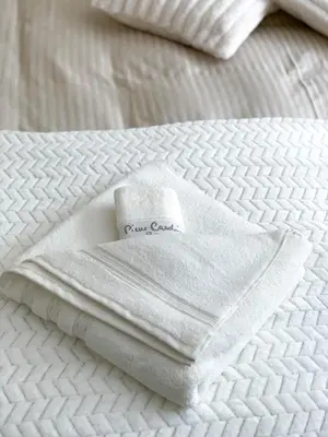 a white towel sitting on top of a bed at Ski Area 202 apt, The Castle 1, Pamporovo in Pamporovo