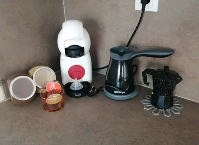 a counter with a coffee maker and a blender at Уютен апартамент на 3 мин. от главната и Капана +паркинг in Plovdiv