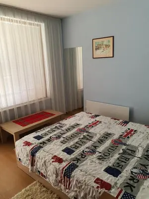a bedroom with a bed with a football quilt on it at Koko's apartments 2 in Bansko
