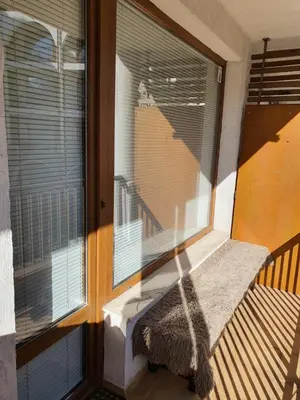 a window with a seat on a balcony at Koko's apartments 2 in Bansko