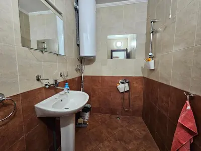 a bathroom with a sink and a shower with a mirror at Apartment Kristin in Apart Hotel Stenata in Pamporovo