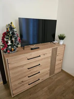 a television on top of a wooden dresser at Apartment Kristin in Apart Hotel Stenata in Pamporovo