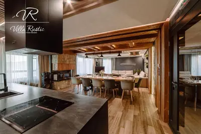 a kitchen and dining room with a table and chairs at Вила Рустик / Villa Rustic in Kyustendil