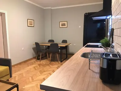 a dining room with a table and chairs at EU metro station, City Center, lovely 3-bedroom apartment, free parking in Sofia