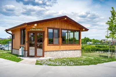 a small building with glass doors on a street at Camping Alliance in Plovdiv