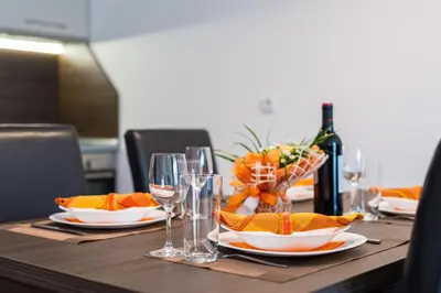 a wooden table with glasses of wine and a bowl of fruit at 4 Seasons Apartment 535, Oak Residence in Smolyan