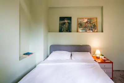 a bedroom with a bed and a table with a lamp at Elegant 2bdr Apartment with a Balcony in Sofia