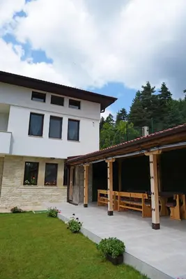 a large white house with a large patio at Вила Релакс in Pamporovo
