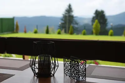 two black vases sitting on top of a table at Вила Релакс in Pamporovo