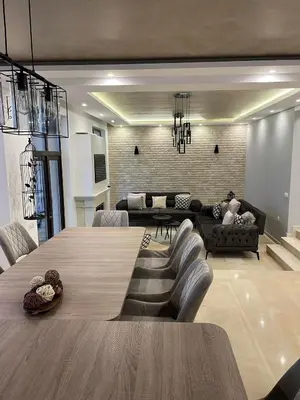 a living room with a large wooden table and chairs at Вила Релакс in Pamporovo