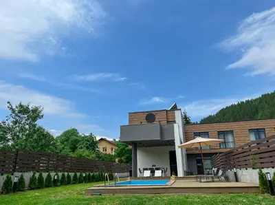 a house with a swimming pool in front of it at Mountain View in Govedartsi