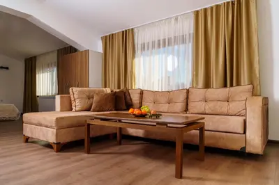 a living room with a couch and a coffee table at Свети Никола in Razlog