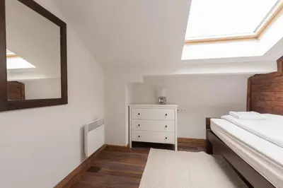 a bedroom with a bed and a mirror and a dresser at Finest Luxury Penthouse Bansko Royal Towers in Bansko