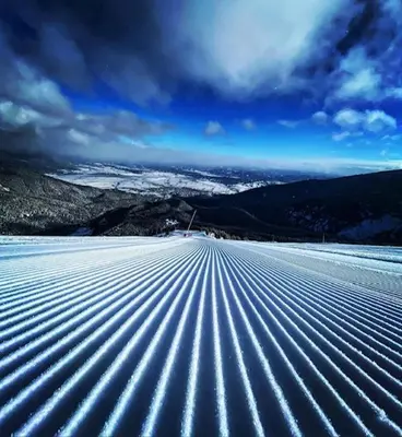 an open road with lines in the snow at Finest Luxury Penthouse Bansko Royal Towers in Bansko