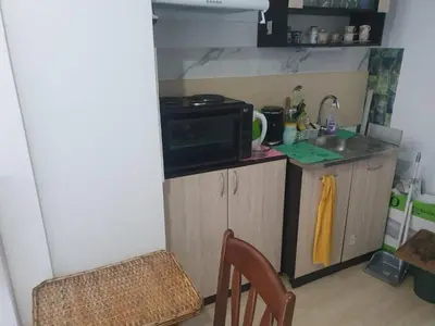a small kitchen with a sink and a microwave at Синьо небе in Bansko