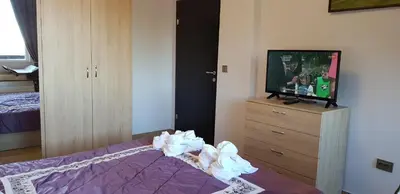 a bedroom with a bed and a tv on a dresser at Lovely Аpartment in IGLIKA 2,Borovets in Borovets