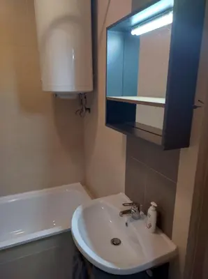 a bathroom with a sink and a mirror and a tub at St John Park Boutique room Gero in Bansko