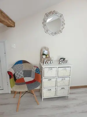 a room with a chair and a dresser with a mirror at Borovets Cozy Mountain Apartments in Borovets