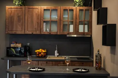 a kitchen with wooden cabinets and a counter top at The White Horse Apartments in Borovets