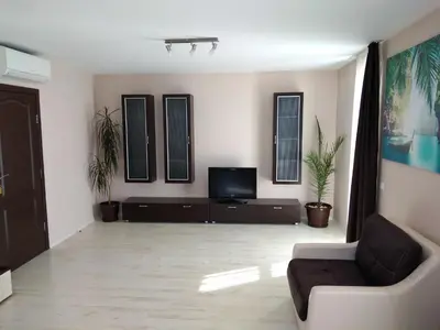a living room with a couch and a tv at Sveti Nikola Villas near Borovets in Shiroki Dol