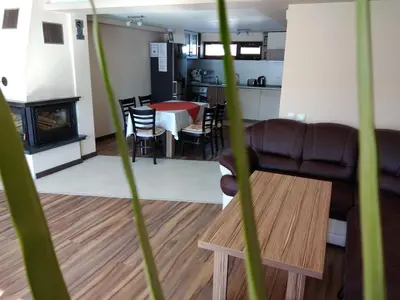 a living room with a table and a couch at Sveti Nikola Villas near Borovets in Shiroki Dol